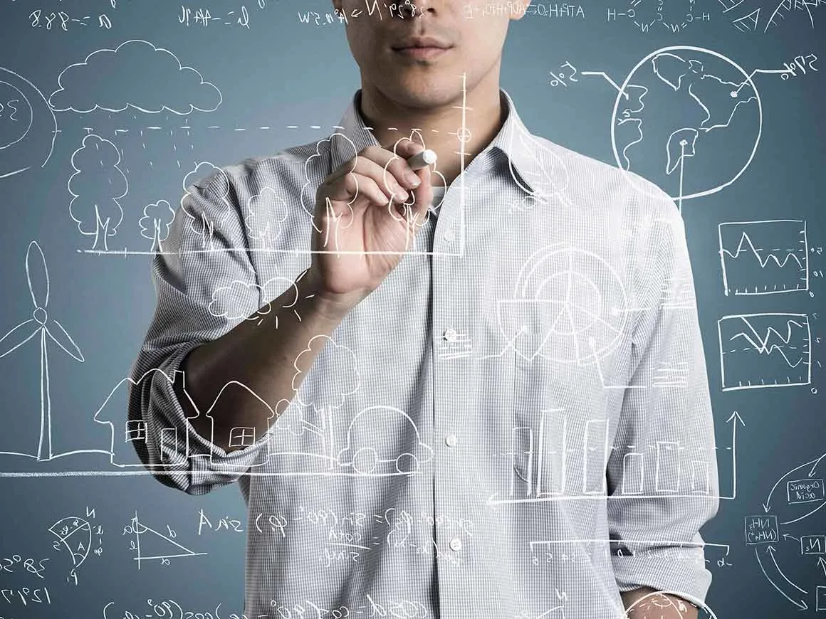 Man writing a formula on a chalkboard